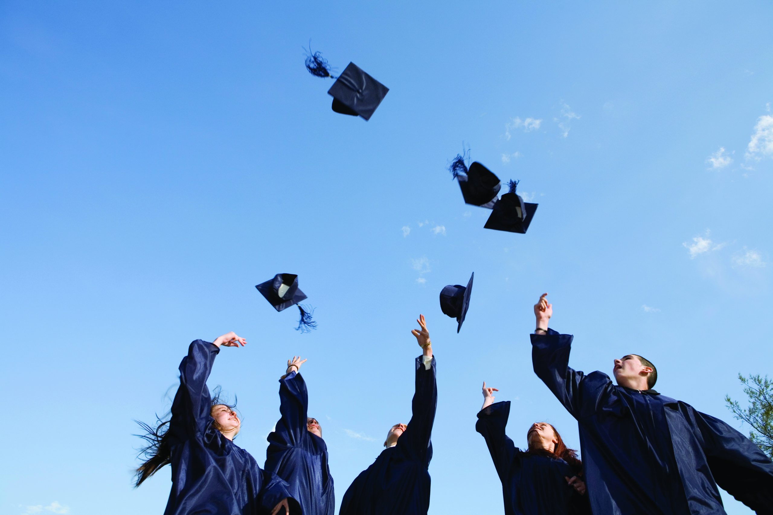 Graduates throwing hats in the air