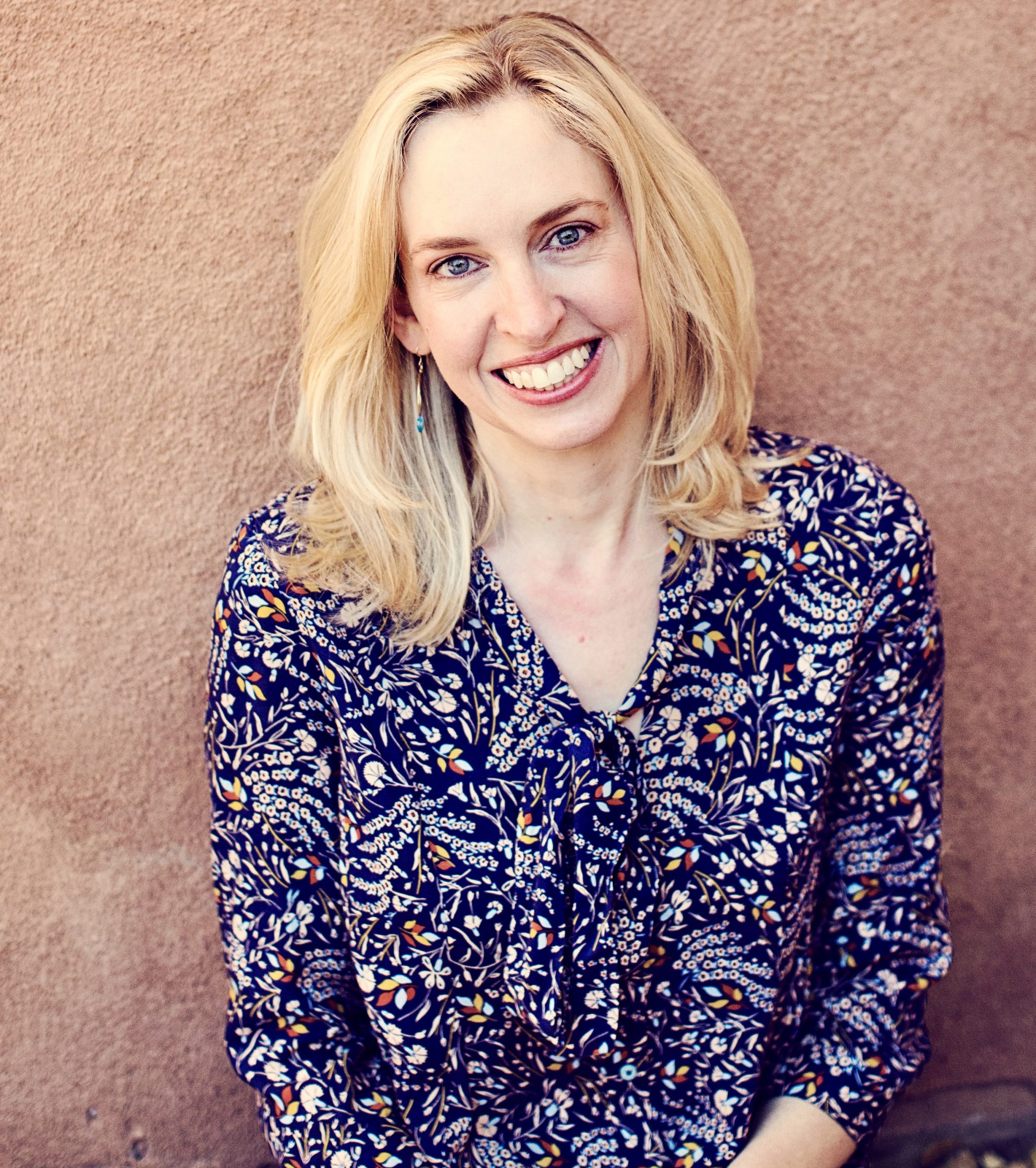 Maddy Mahony with adobe wall in background