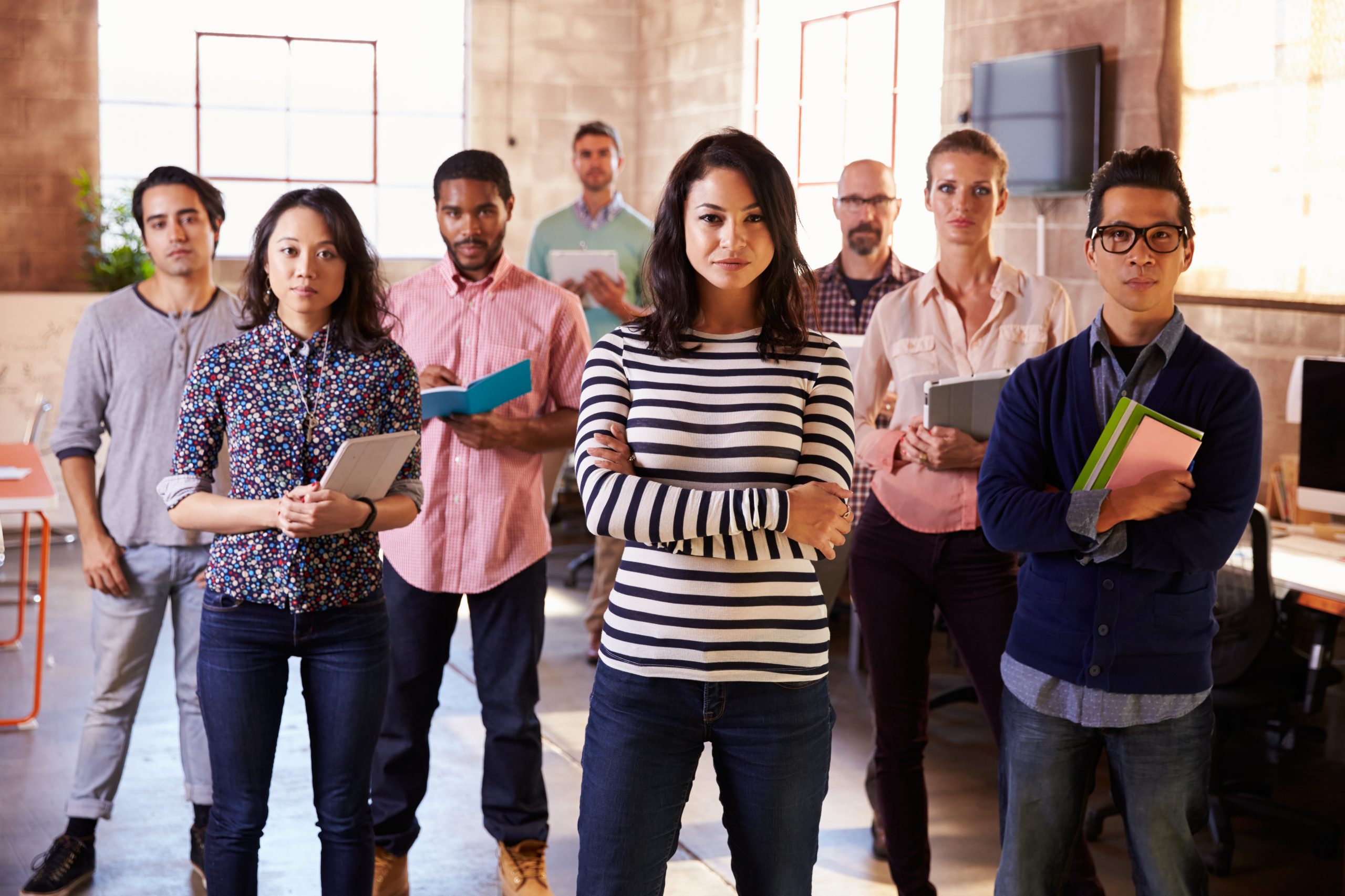 A group of high school and/or college-aged students standing and facing the camera.